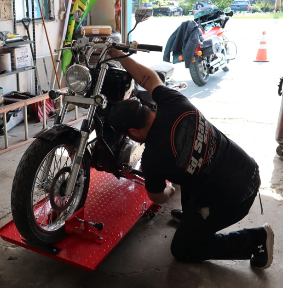 Technician fixing motorcycle